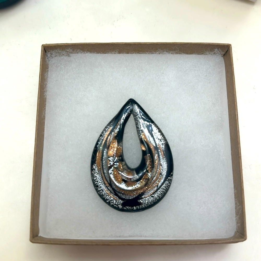 2 inch black, silver and gold accented, handmade glass pendant